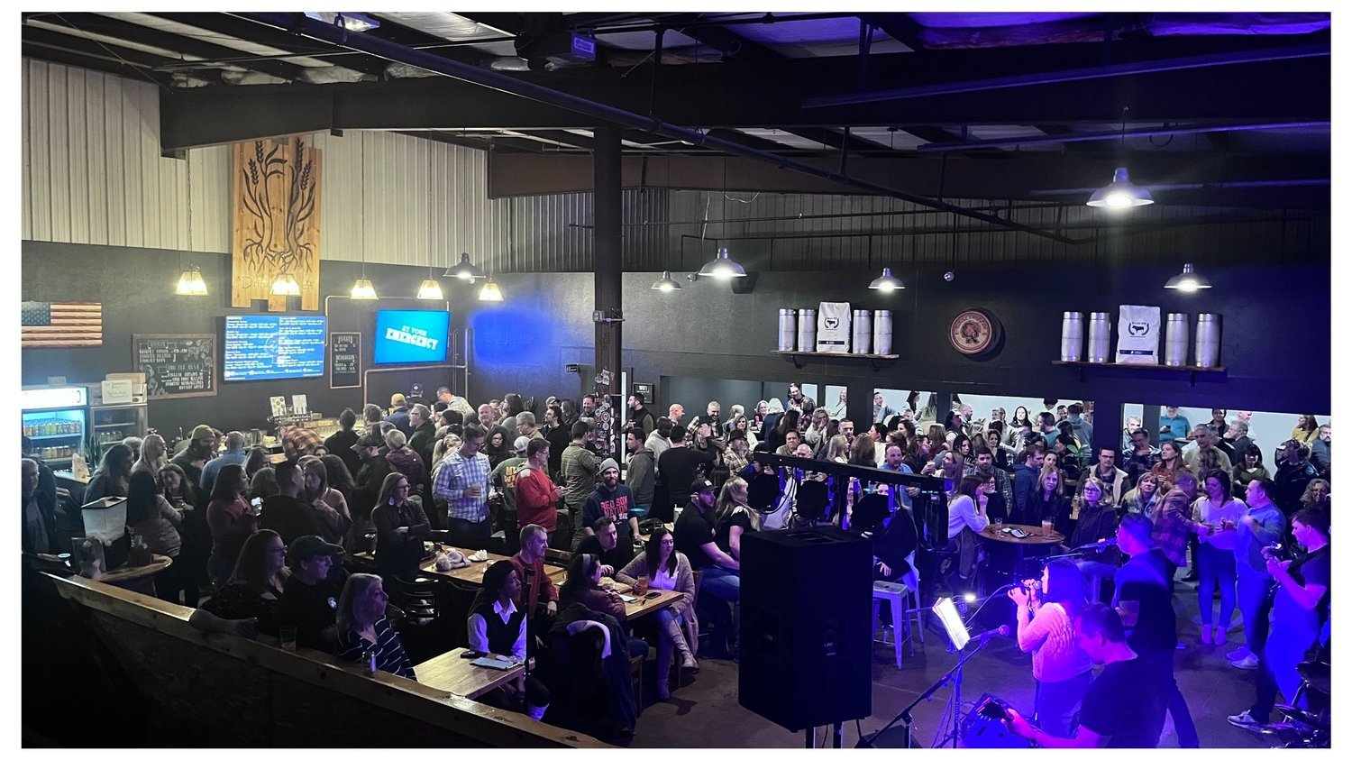 A full CraftRoots taproom during a live music performance