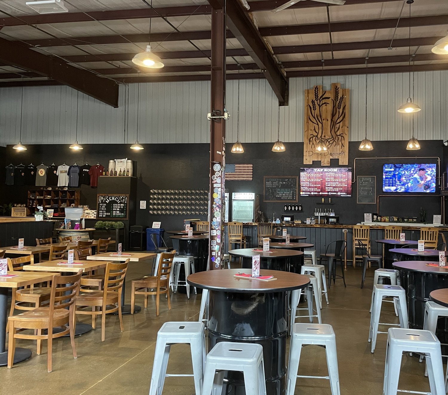 Friends and neighbors gathered around tables and the bar in the CraftRoots taproom